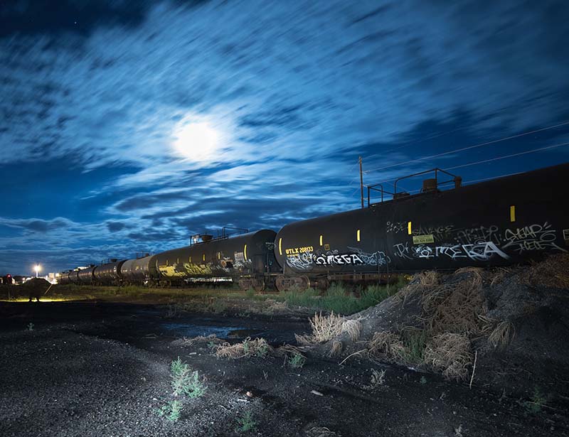 abandoned train under a dramatic full moon